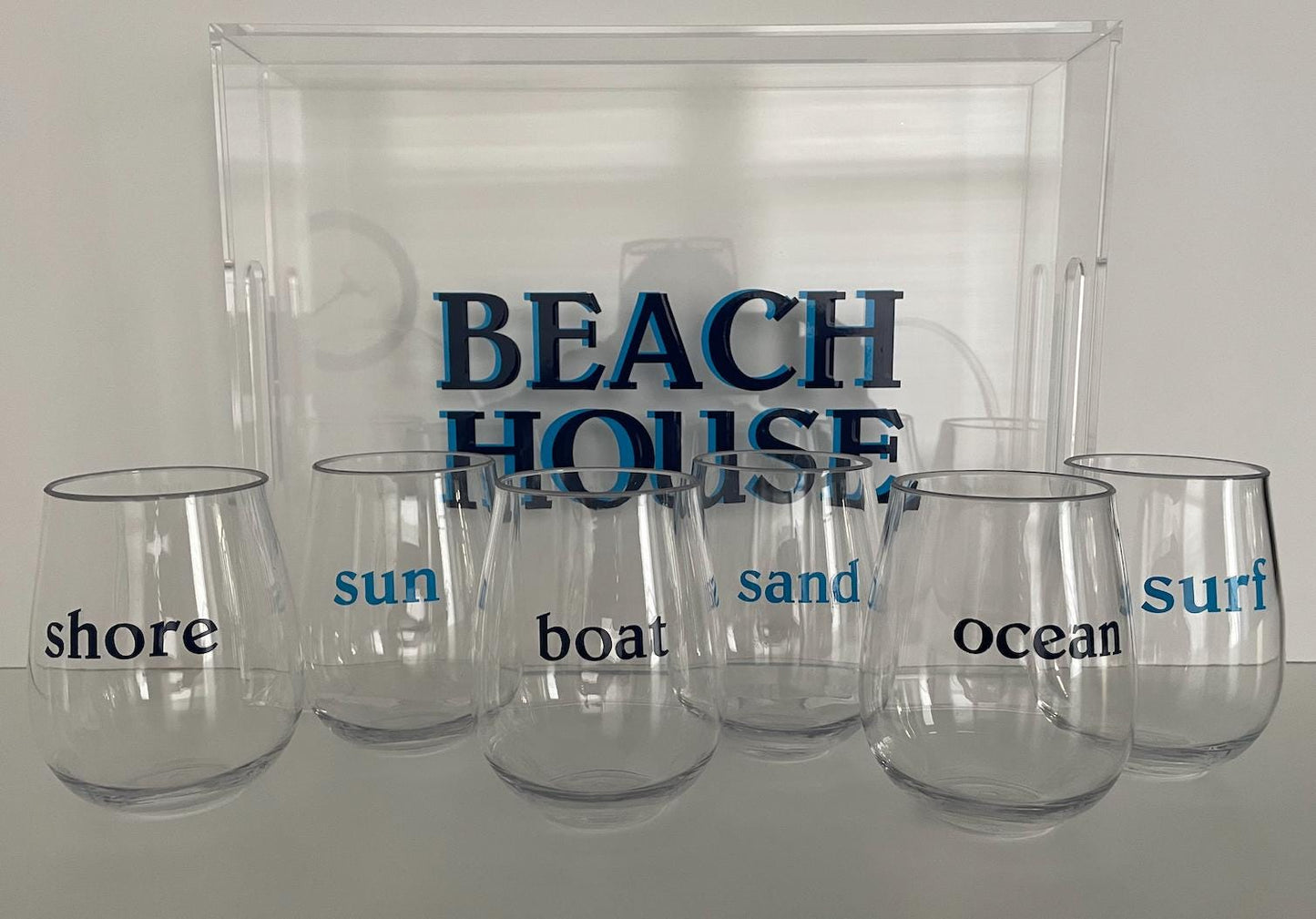 personalized 11" x 14" clear acrylic tray with vinyl BEACH in the center and 6 stemless wine glasses with fun beachy sayings