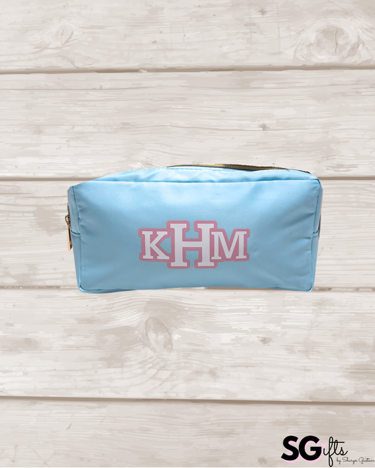 Light blue nylon makeup bag with classic monogram