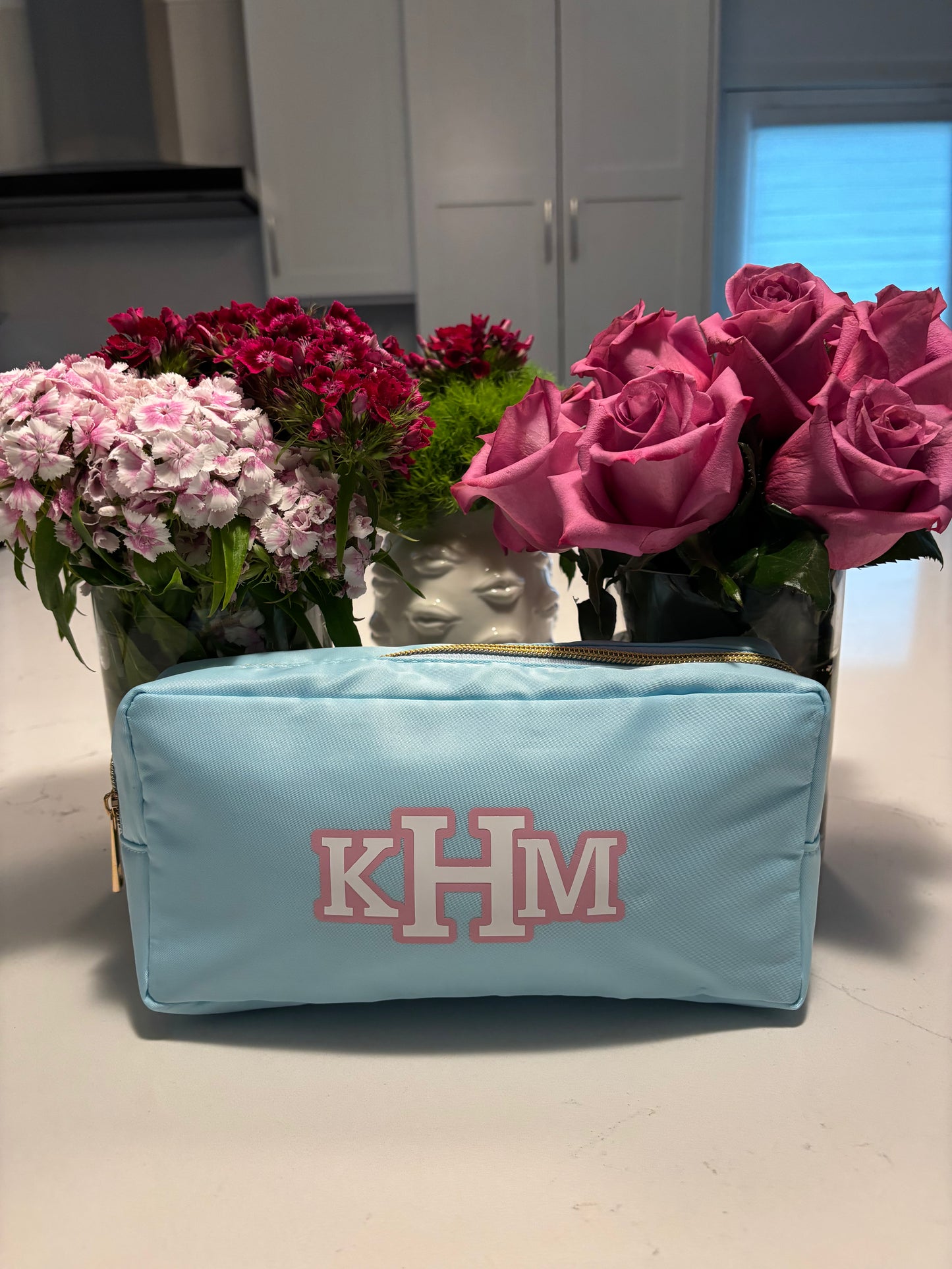 light blue nylon makeup bag with classic monogram