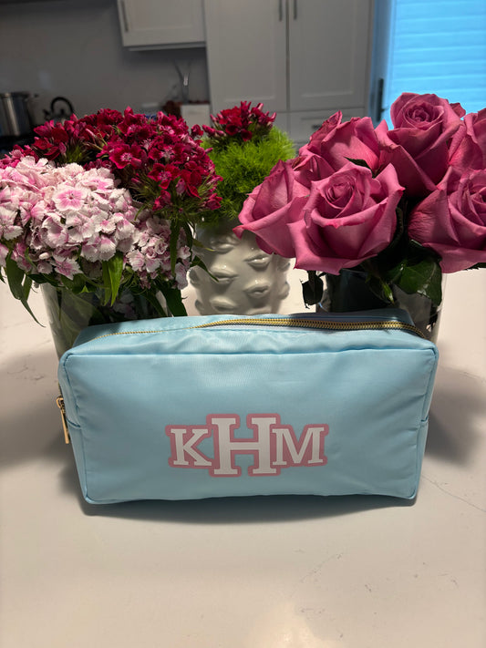 light blue nylon makeup bag with classic monogram
